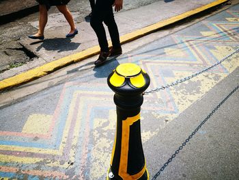 Low section of men standing on sidewalk
