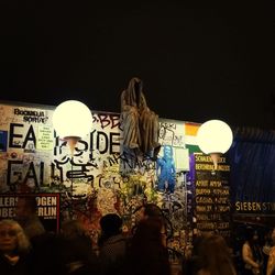 Low angle view of illuminated people at night