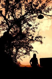 Silhouette of bare tree against sky at sunset