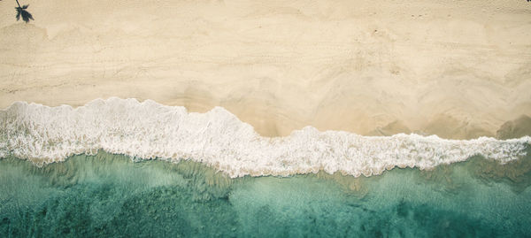 Aerial view of beach against sky during sunset