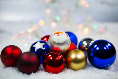 Close-up of multi colored balls in snow