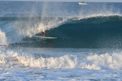 Low section of person surfing in sea