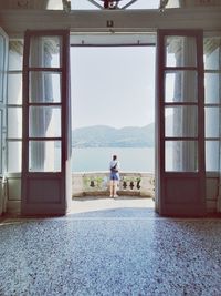 Man standing at entrance of building