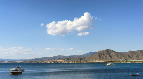 Sailboats in sea against sky