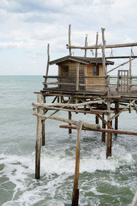 Built structure in sea against sky