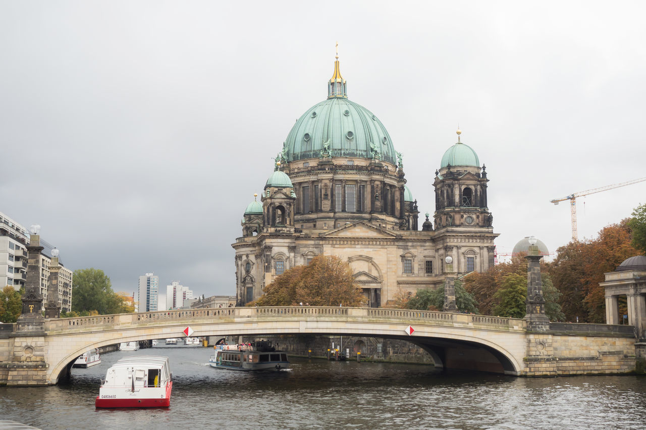 architecture, built structure, dome, religion, bridge - man made structure, water, building exterior, sky, place of worship, spirituality, river, transportation, connection, cloud - sky, day, mode of transport, travel, outdoors, travel destinations, city, no people, nautical vessel, nature