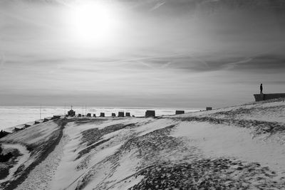 Scenic view of beach against sky during winter