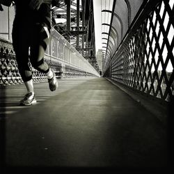 Low section of woman walking on road