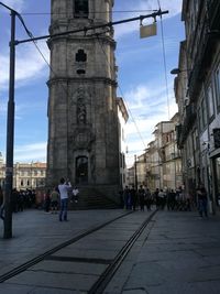 People walking on street amidst buildings in city