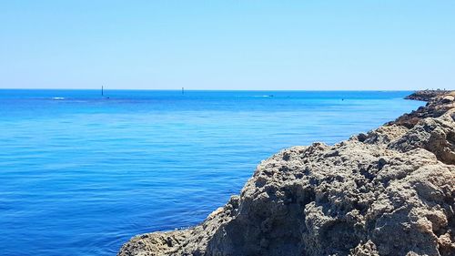 View of calm blue sea against clear sky