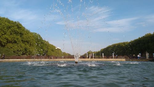 Scenic view of swimming pool by lake against sky