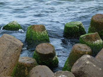 High angle view of rocks on sea shore