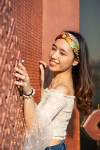 Portrait of a smiling young woman looking away