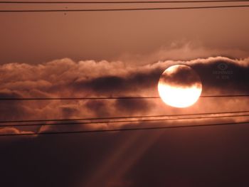 Low angle view of moon against sky during sunset