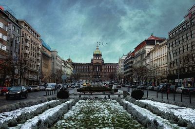 Snow covered road in city