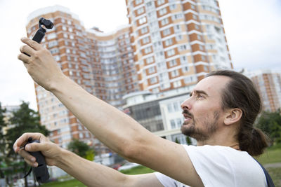 Side view of man using mobile phone
