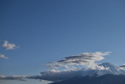 Low angle view of snowcapped mountain against sky