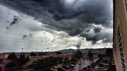 Car on road against cloudy sky