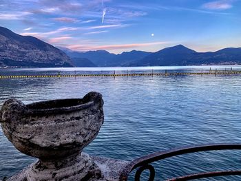 Scenic view of lake by mountains against sky