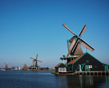 Traditional windmill against clear blue sky