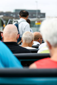 Rear view of people sitting in vehicle