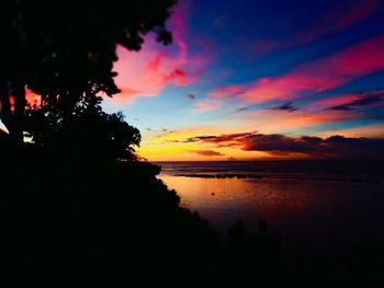 Scenic view of sea against romantic sky at sunset