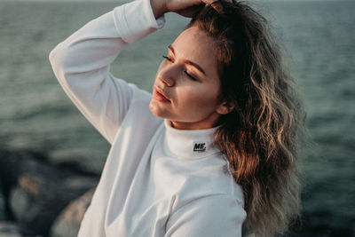 Portrait of beautiful woman standing in sea