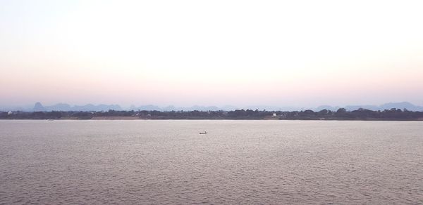 Scenic view of sea against clear sky during sunset