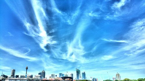 Low angle view of modern buildings against blue sky