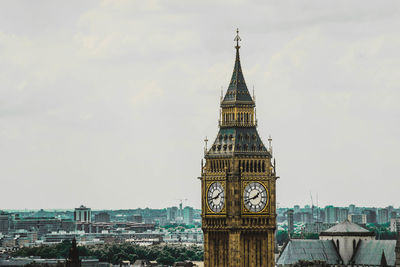 Clock tower in city against sky