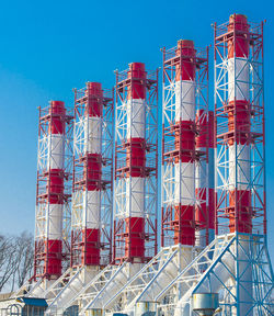 Low angle view of towers against clear blue sky