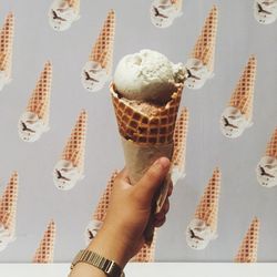 Close-up of hand holding ice cream cone