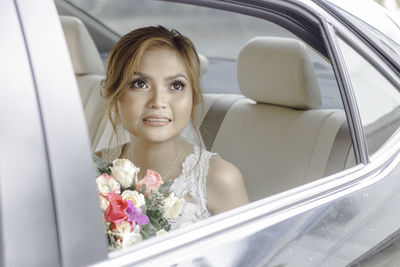 Portrait of woman sitting in car