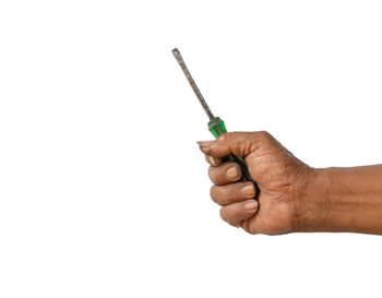 Close-up of man holding hands against white background