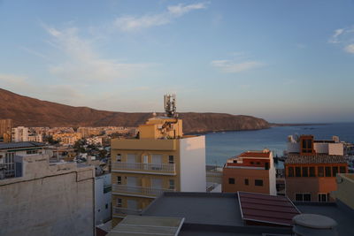 Townscape by sea against sky in city