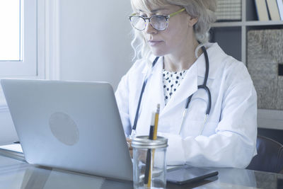 Midsection of woman using mobile phone