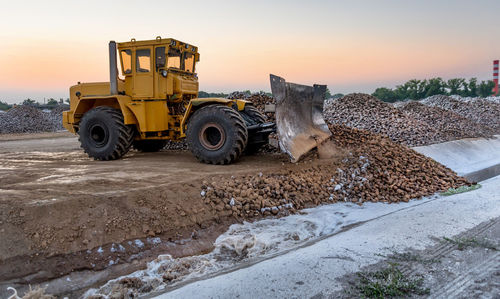 View of bulldozer at sunset