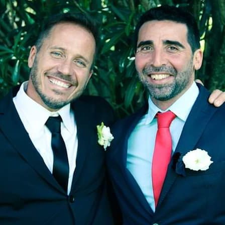 men, adult, smiling, happiness, two people, emotion, portrait, celebration, married, positive emotion, love, cheerful, togetherness, wedding, formal wear, looking at camera, plant, event, business, bride, person, wedding ceremony, life events, ceremony, flower, beard, nature, young adult, facial hair, menswear, necktie, wedding dress, bonding, smile, teeth, clothing, marriage, tuxedo, civil partnership, tie, headshot, romance