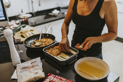 Midsection of man preparing food in kitchen