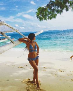 Full length of woman on beach against sky