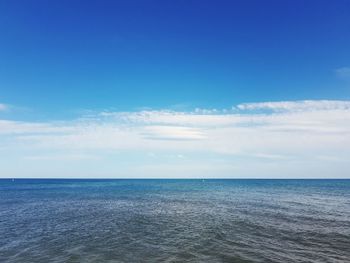 Scenic view of sea against blue sky