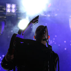 Rear view of man performing at music concert