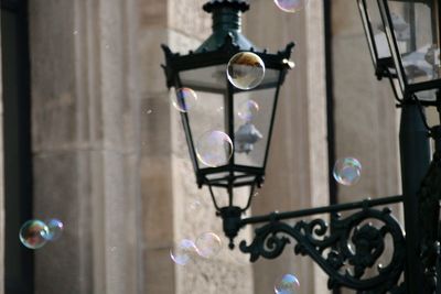 Close-up of soap bubbles against street lamp