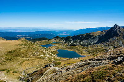 Scenic view of mountains against blue sky