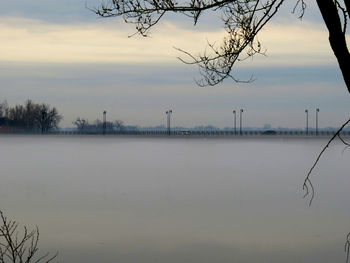 Scenic view of lake against sky at sunset