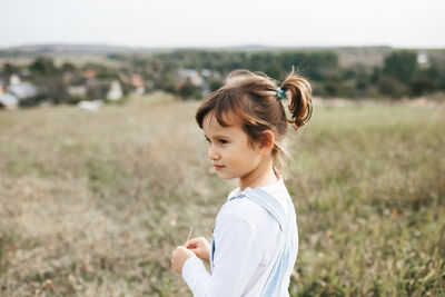 Side view of woman standing on field