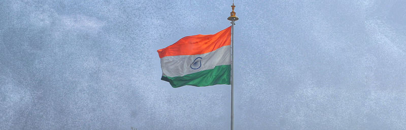 Low angle view of flag against sky