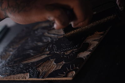 Cropped hand of man working at workshop