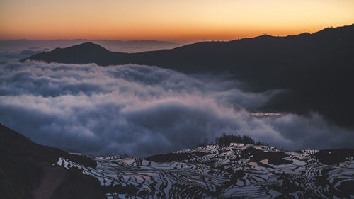 Scenic view of mountains against sky during sunset