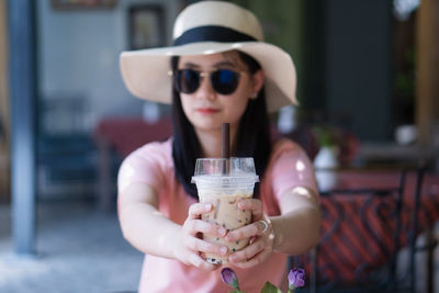 Portrait of woman drinking glass